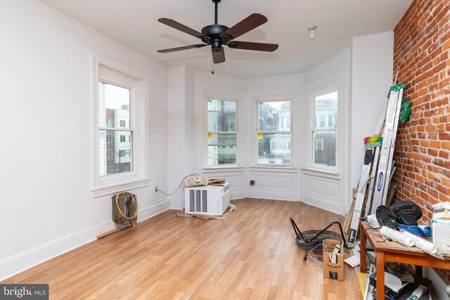 2308 N Park Ave, Philadelphia, PA 19132 - sunroom / solarium featuring wood finished floors, baseboards, and brick wall