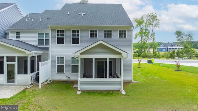 35031 Dundee St Unit 6, Frankford, DE 19945 - rear view of property featuring a sunroom, a lawn, and a shingled roof