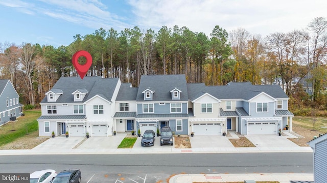 35031 Dundee St Unit 6, Frankford, DE 19945 - view of front of home with a standing seam roof, driveway, and a garage