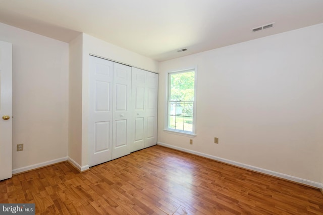 18552 Three Notch Rd, Lexington Park, MD 20653 - unfurnished bedroom featuring light wood finished floors, baseboards, and a closet