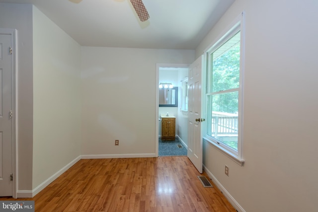 18552 Three Notch Rd, Lexington Park, MD 20653 - unfurnished bedroom featuring light wood-style flooring, multiple windows, baseboards, and ensuite bath