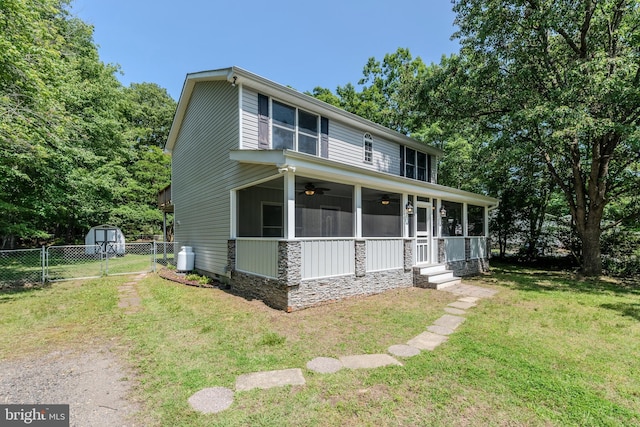 18552 Three Notch Rd, Lexington Park, MD 20653 - view of front of home with ceiling fan, a sunroom, and stone siding