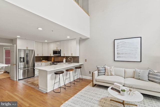 1406 Corcoran St NW Unit D, Washington, DC 20009 - living area with light wood-style floors and recessed lighting