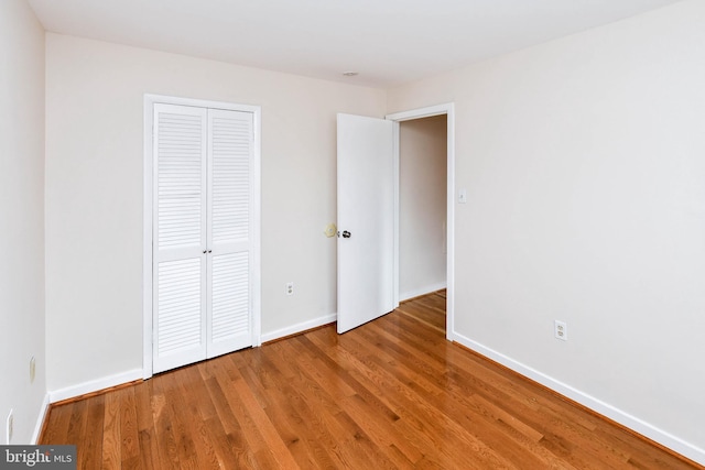 49 Hawthorne Ct NE Unit 49, Washington, DC 20017 - unfurnished bedroom featuring baseboards, a closet, and wood finished floors