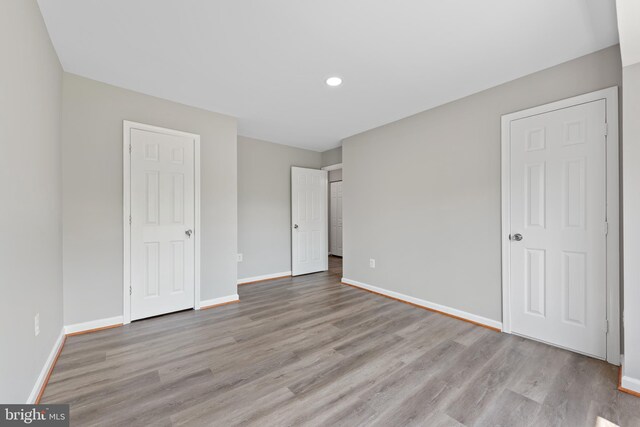 10779 Primrose Ct, Manassas, VA 20109 - unfurnished bedroom featuring wood finished floors, baseboards, and recessed lighting