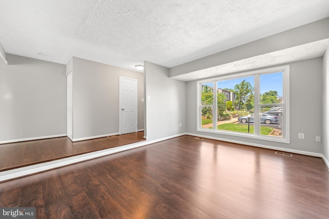 10779 Primrose Ct, Manassas, VA 20109 - empty room with a textured ceiling, wood finished floors, and baseboards