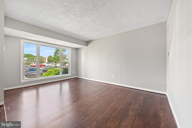 10779 Primrose Ct, Manassas, VA 20109 - spare room with dark wood-style floors, baseboards, and a textured ceiling
