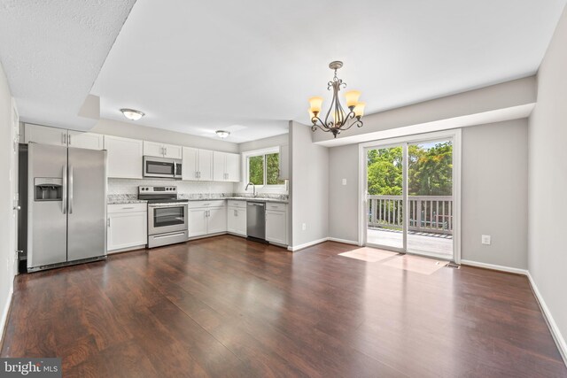 10779 Primrose Ct, Manassas, VA 20109 - kitchen featuring stainless steel appliances, a chandelier, dark wood-style floors, white cabinetry, and baseboards