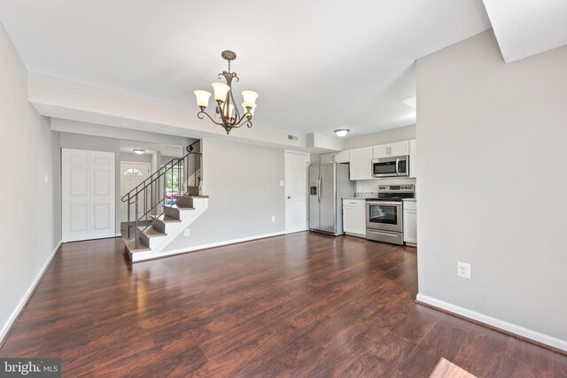 10779 Primrose Ct, Manassas, VA 20109 - kitchen featuring appliances with stainless steel finishes, white cabinetry, dark wood-style floors, a chandelier, and baseboards