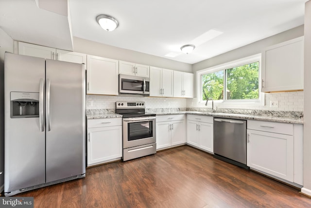 10779 Primrose Ct, Manassas, VA 20109 - kitchen featuring appliances with stainless steel finishes, backsplash, white cabinets, and dark wood-style floors