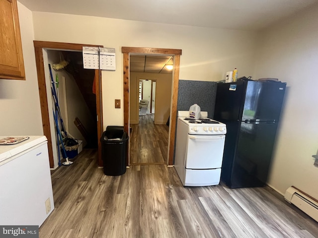 619-621 Riverside Dr, Lewistown, PA 17044 - kitchen featuring white range oven, a baseboard radiator, freestanding refrigerator, wood finished floors, and light countertops