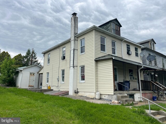 619-621 Riverside Dr, Lewistown, PA 17044 - back of property with a chimney, covered porch, and a yard
