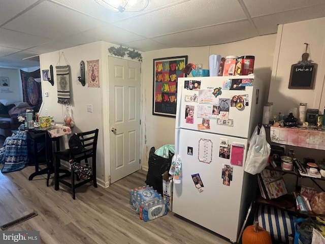 619-621 Riverside Dr, Lewistown, PA 17044 - kitchen with freestanding refrigerator, light wood-type flooring, and a paneled ceiling