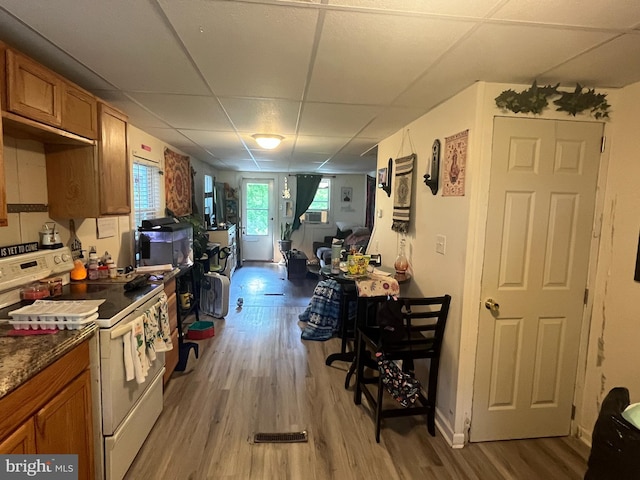 619-621 Riverside Dr, Lewistown, PA 17044 - kitchen featuring white electric range oven, a paneled ceiling, brown cabinets, light wood-style floors, and open floor plan