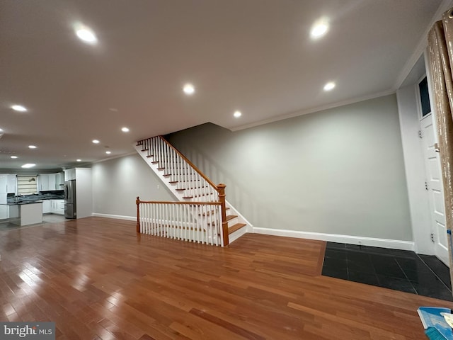 916 Snyder Ave, Philadelphia, PA 19148 - unfurnished living room featuring crown molding, dark wood finished floors, baseboards, stairway, and recessed lighting