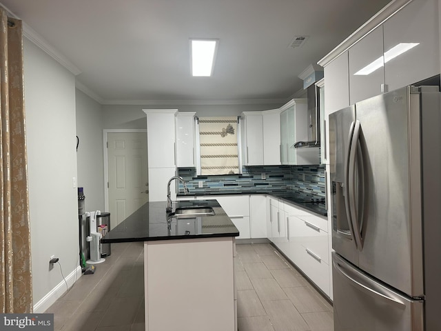 916 Snyder Ave, Philadelphia, PA 19148 - kitchen featuring stainless steel fridge, a sink, dark countertops, tasteful backsplash, and white cabinetry