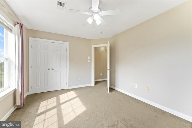 17760 Julie Ann Ct, Hamilton, VA 20158 - unfurnished bedroom with light colored carpet, baseboards, a closet, and a ceiling fan