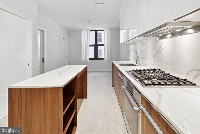 1427 Rhode Island Ave NW Unit 202, Washington, DC 20005 - kitchen with a sink, oven, modern cabinets, stainless steel gas cooktop, and open shelves