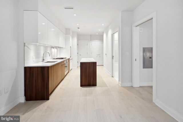 1427 Rhode Island Ave NW Unit 202, Washington, DC 20005 - kitchen featuring modern cabinets, white cabinets, a sink, a kitchen island, and light countertops