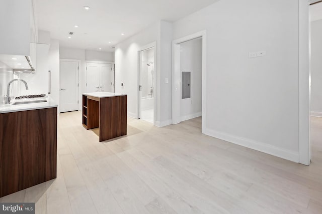 1427 Rhode Island Ave NW Unit 202, Washington, DC 20005 - kitchen with a center island, light countertops, modern cabinets, light wood-type flooring, and a sink