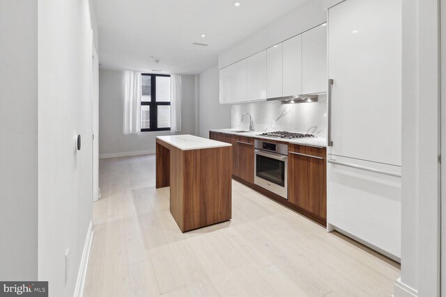 1427 Rhode Island Ave NW Unit 202, Washington, DC 20005 - kitchen with stainless steel appliances, modern cabinets, a kitchen island, a sink, and white cabinets