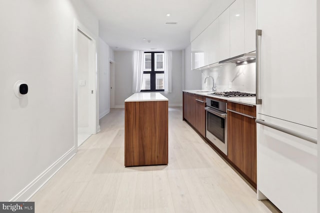 1427 Rhode Island Ave NW Unit 202, Washington, DC 20005 - kitchen with appliances with stainless steel finishes, modern cabinets, a center island, and white cabinetry