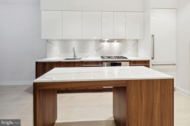 1427 Rhode Island Ave NW Unit 202, Washington, DC 20005 - kitchen featuring modern cabinets, baseboards, a sink, white cabinetry, and decorative backsplash