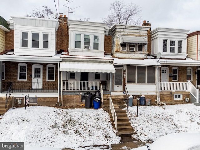 1011 Andrews Ave, Darby, PA 19023 - view of property with covered porch, stairs, brick siding, and a chimney