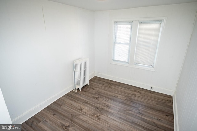 1011 Andrews Ave, Darby, PA 19023 - spare room featuring radiator, dark wood-style floors, and baseboards