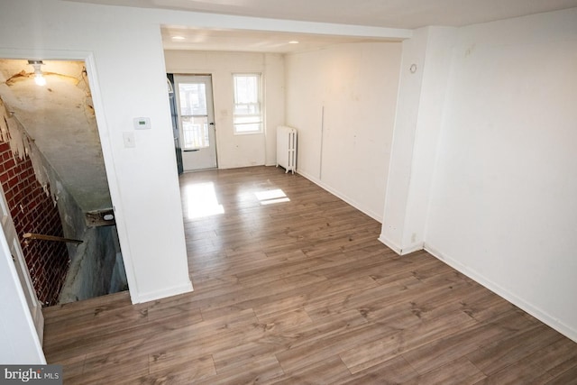 1011 Andrews Ave, Darby, PA 19023 - unfurnished room featuring radiator, wood finished floors, and baseboards