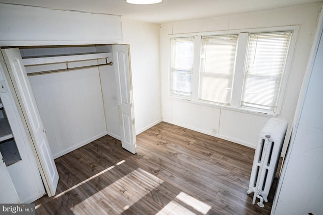1011 Andrews Ave, Darby, PA 19023 - unfurnished bedroom featuring radiator, wood finished floors, and a closet