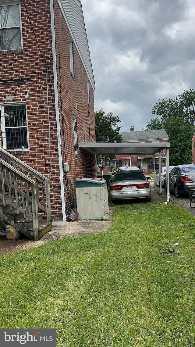 3707 Howard Park Ave, Baltimore, MD 21207 - view of side of property featuring brick siding, a yard, and a carport