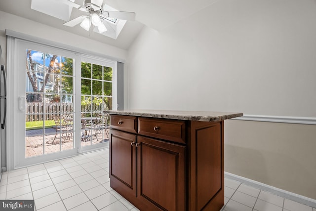 13 Honey Locust Ln, Newtown, PA 18940 - kitchen featuring vaulted ceiling, a skylight, light tile patterned flooring, ceiling fan, and baseboards