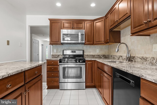 13 Honey Locust Ln, Newtown, PA 18940 - kitchen with stainless steel appliances, a sink, tasteful backsplash, light tile patterned flooring, and recessed lighting