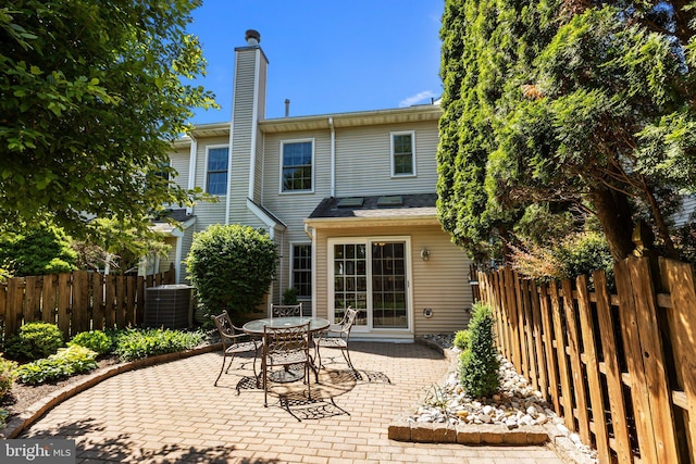 13 Honey Locust Ln, Newtown, PA 18940 - rear view of house featuring a patio area, cooling unit, a chimney, and outdoor dining area