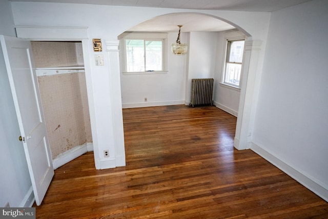 6982 Clinton Rd, Upper Darby, PA 19082 - unfurnished bedroom featuring radiator heating unit, arched walkways, wood finished floors, a chandelier, and baseboards