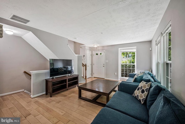 3218 Water Lily Ct, Laurel, MD 20724 - living area with a textured ceiling, light wood-style floors, and baseboards