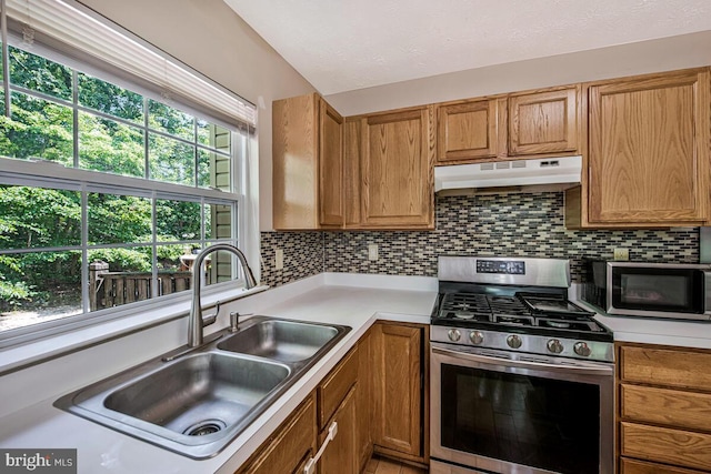 3218 Water Lily Ct, Laurel, MD 20724 - kitchen featuring appliances with stainless steel finishes, under cabinet range hood, a sink, light countertops, and decorative backsplash