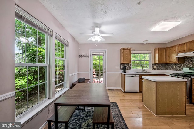 3218 Water Lily Ct, Laurel, MD 20724 - kitchen with dishwasher, gas range, a sink, under cabinet range hood, and a kitchen island