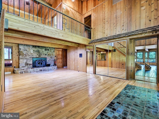 2511 W Norwegian St, Pottsville, PA 17901 - unfurnished living room with a towering ceiling, wooden walls, and wood-type flooring