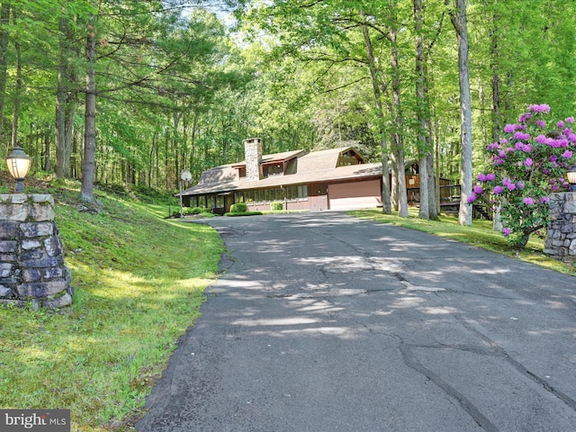 2511 W Norwegian St, Pottsville, PA 17901 - mid-century inspired home featuring asphalt driveway, a chimney, and a view of trees