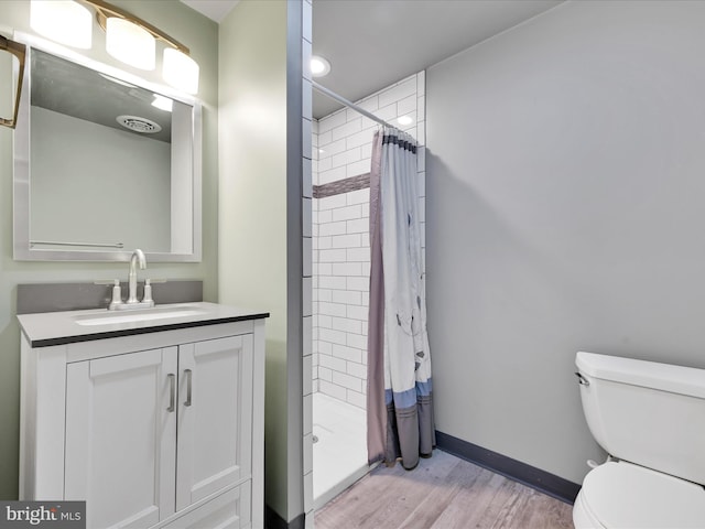 2511 W Norwegian St, Pottsville, PA 17901 - full bathroom featuring wood finished floors, toilet, a shower stall, vanity, and baseboards