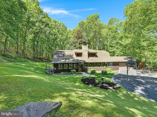 2511 W Norwegian St, Pottsville, PA 17901 - view of front of home featuring driveway, a front yard, a chimney, an attached garage, and a wooded view