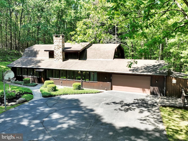 2511 W Norwegian St, Pottsville, PA 17901 - view of front facade with asphalt driveway, an attached garage, a chimney, and a view of trees