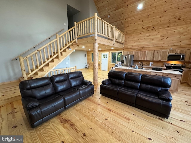 68 Taylor Ln, Mc Henry, MD 21541 - living area with high vaulted ceiling, light wood-type flooring, and stairs