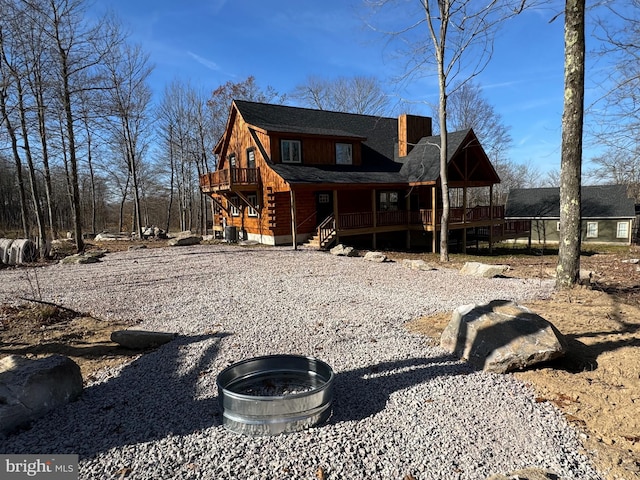 68 Taylor Ln, Mc Henry, MD 21541 - rear view of property featuring log siding, a porch, a chimney, roof with shingles, and stairway