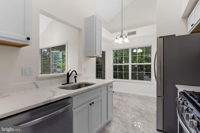 5948 Founders Hill Dr Unit 301, Alexandria, VA 22310 - kitchen with stainless steel appliances, a sink, light marble finish floors, a chandelier, and light stone countertops