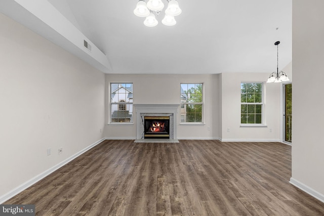 5948 Founders Hill Dr Unit 301, Alexandria, VA 22310 - unfurnished living room featuring a chandelier, dark wood-style flooring, a premium fireplace, and baseboards