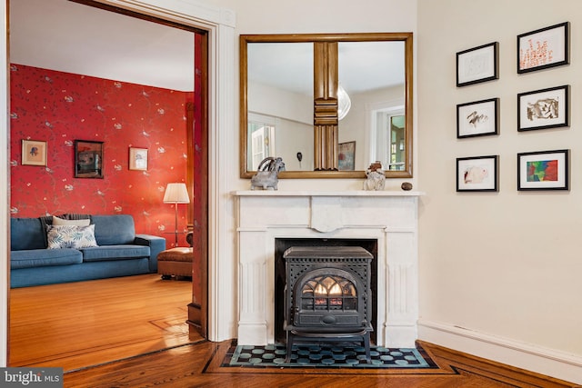 127 Webster Ave, Wyncote, PA 19095 - living room featuring wallpapered walls, a wood stove, and wood finished floors