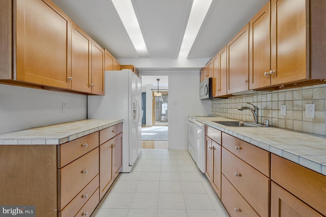 11174 Glade Dr, Reston, VA 20191 - kitchen with backsplash, white refrigerator with ice dispenser, a sink, stainless steel microwave, and light tile patterned flooring